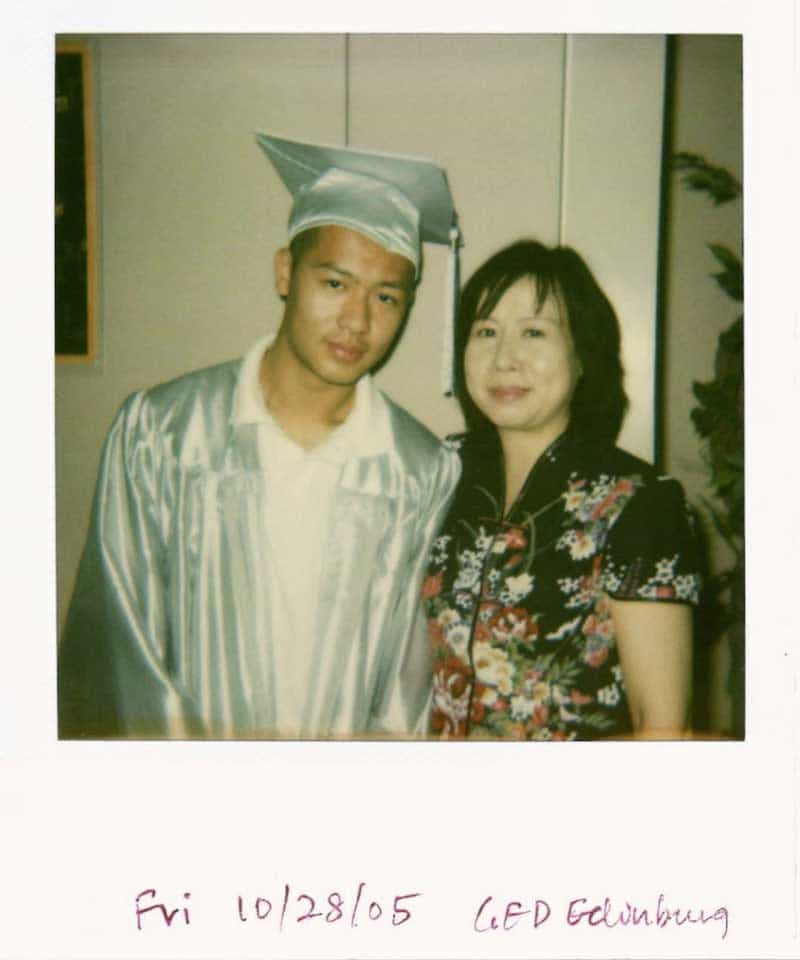 Jason Wang in a cap and gown wih his mother - a polaroid with the text Fri 10/28/05 GED Edinburg