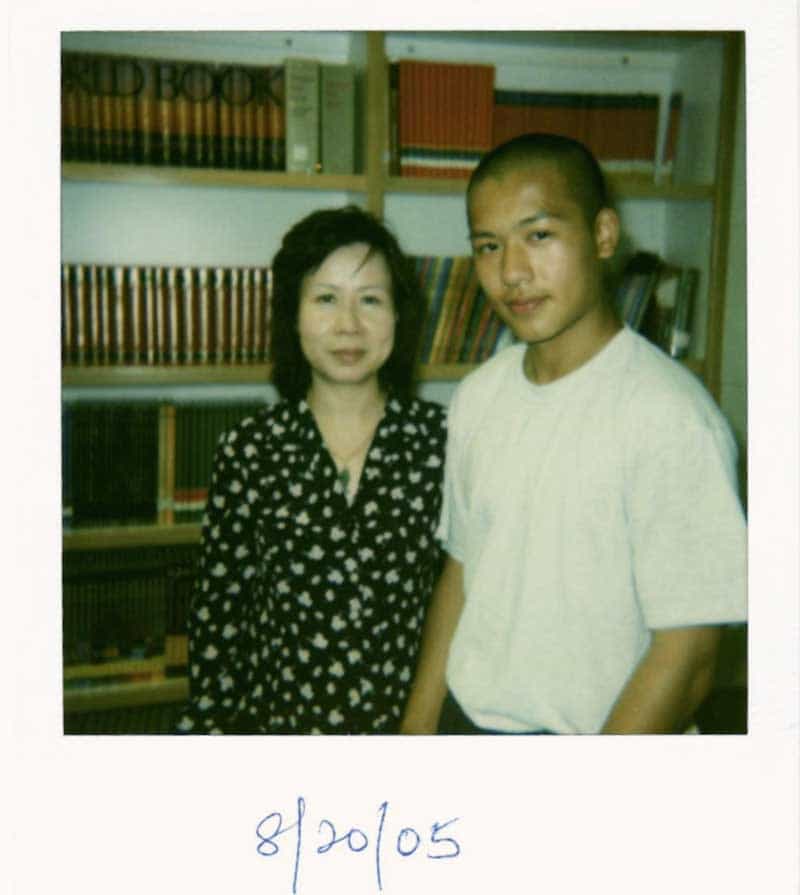 A polaroid of Jason Wang and his mother in front of bookshelves, dated 8/20/05