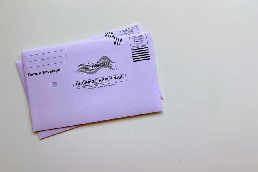 A purple return envelope for mail in voting