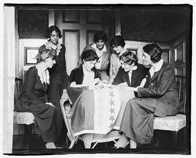 Suffragists sewing stars on suffrage flag / Photo courtesy of the Library of Congress