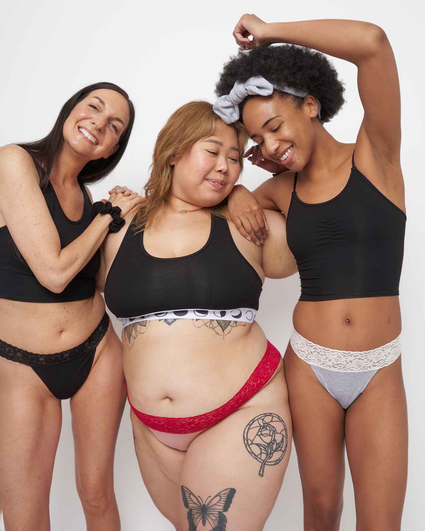 Three women in a studio smiling, wearing Miakoda's ethically sourced underwear