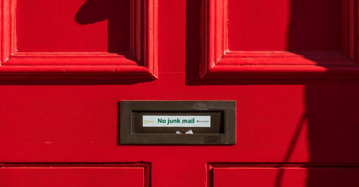 Mail slot in a red door that says "No junk mail"