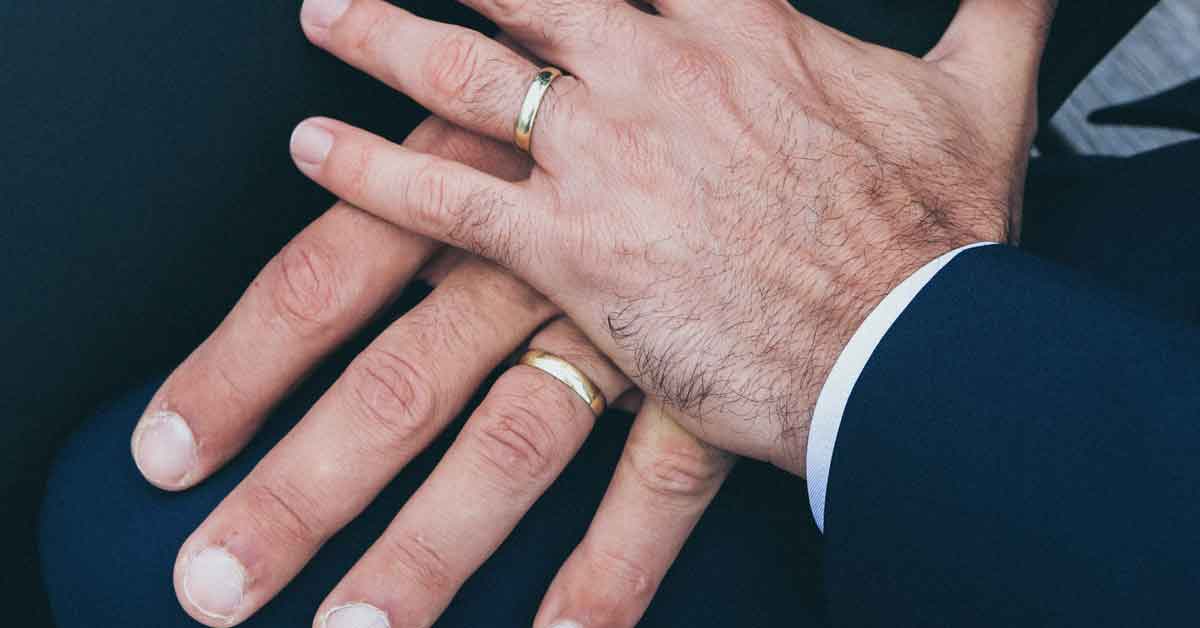Closeup of men's hands with wedding rings