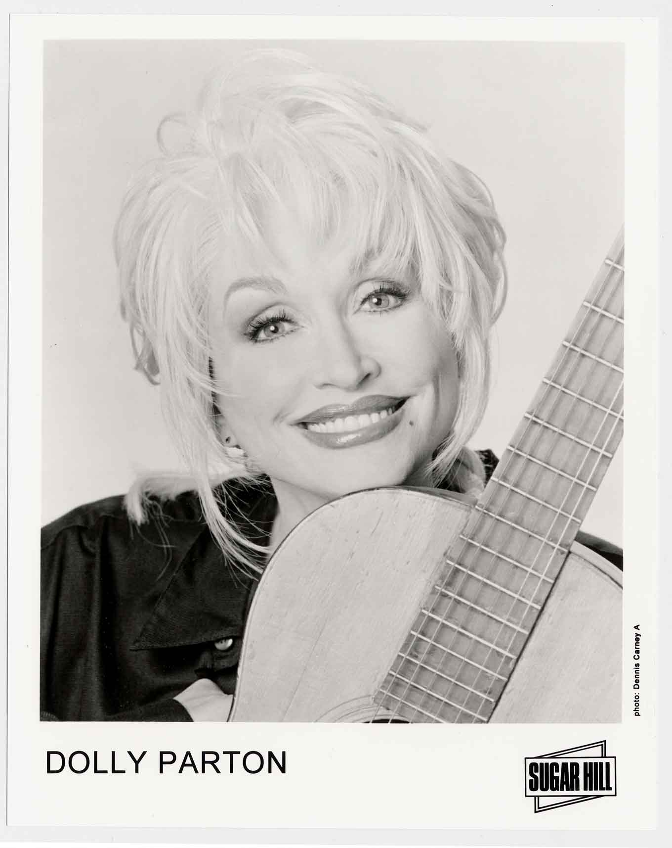 Dolly Parton portrait, smiling with a guitar