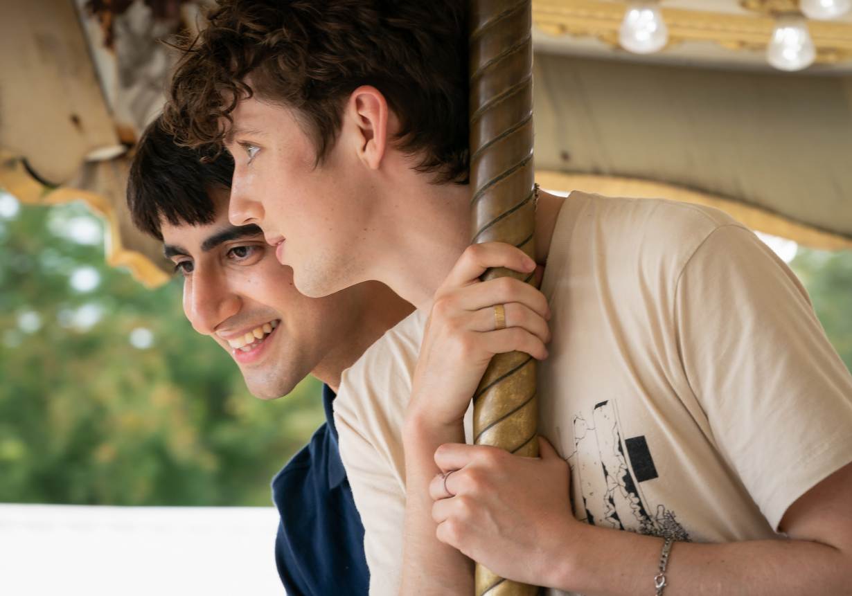 A still from the film 'Three Months', picturing Troye Sivan, who plays Caleb, and Viveik Kalra who plays Esther, on a fairground ride