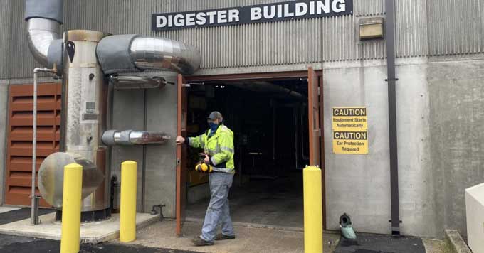 A worker outside of the Digester Building