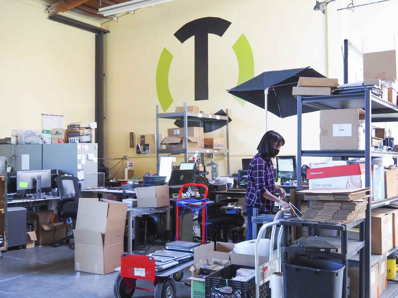 A Tech Exchange employee works in the nonprofit’s warehouse in May 2021. She and her colleagues spent months working on #OaklandUndivided devices.