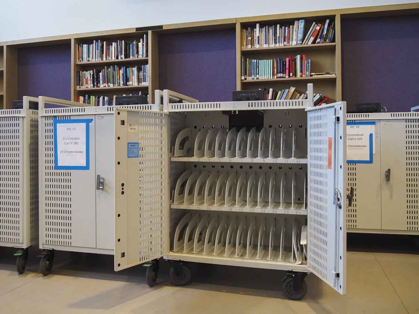 Inside Castlemont’s media center in May 2021, Chromebook carts are completely empty. In the early days of the pandemic, every Chromebook on campus was lent out to students during remote learning.