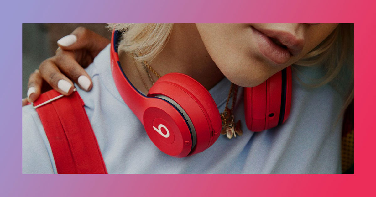 A Girl Wearing Product RED Products including Apple Beats and a bag