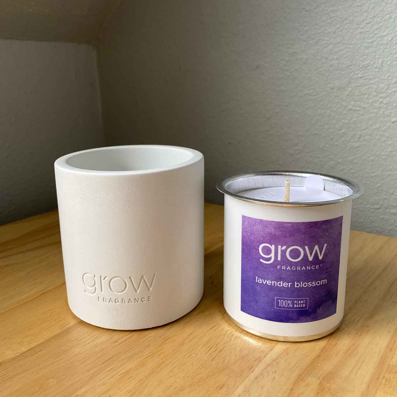 A white concrete vessel, an the aluminum candle insert from Grow Fragrances, with a label that says lavender blossume
