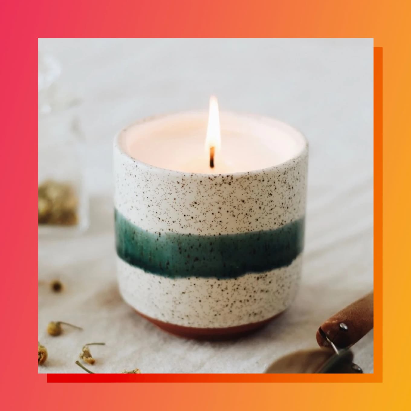 A ceramic soy wax candle with a green stripe