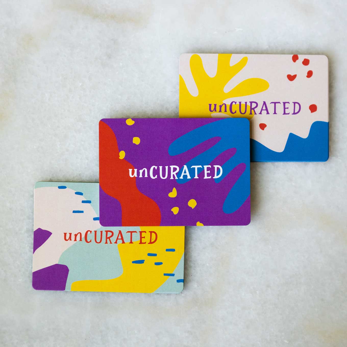 Colorful cards that say unCURATED