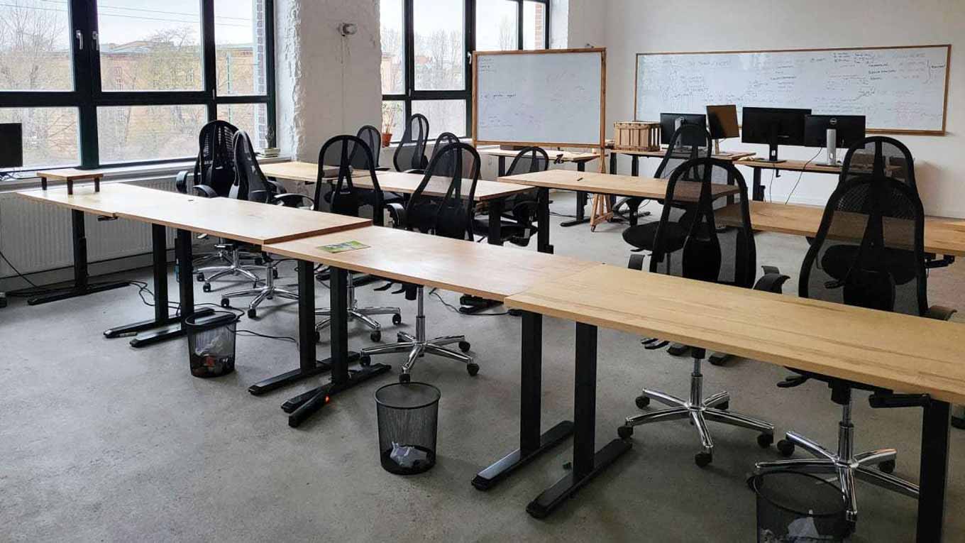 A tech office's conference room converted into a classroom for refugees