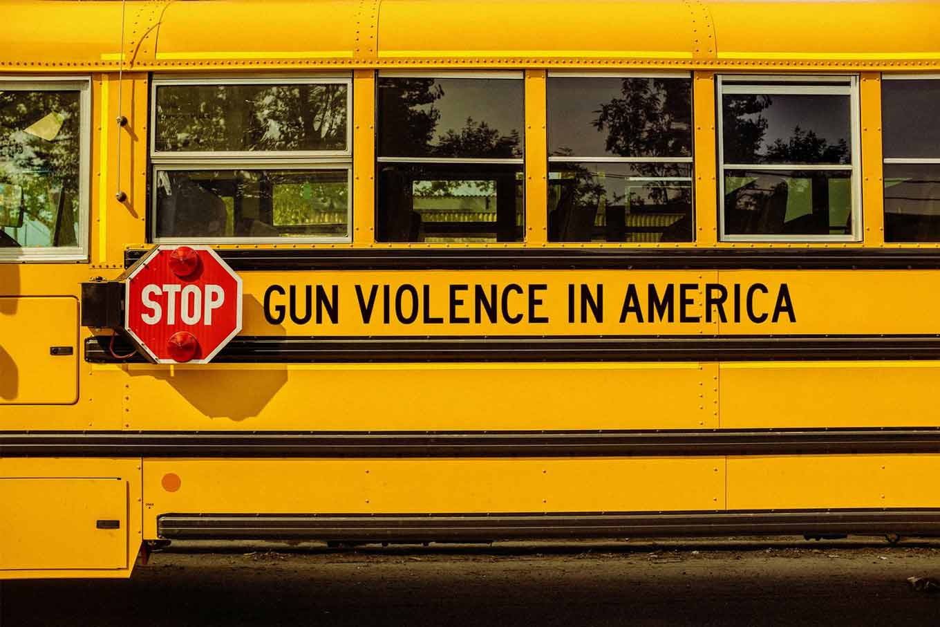 A yellow school bus that says STOP gun violence in America