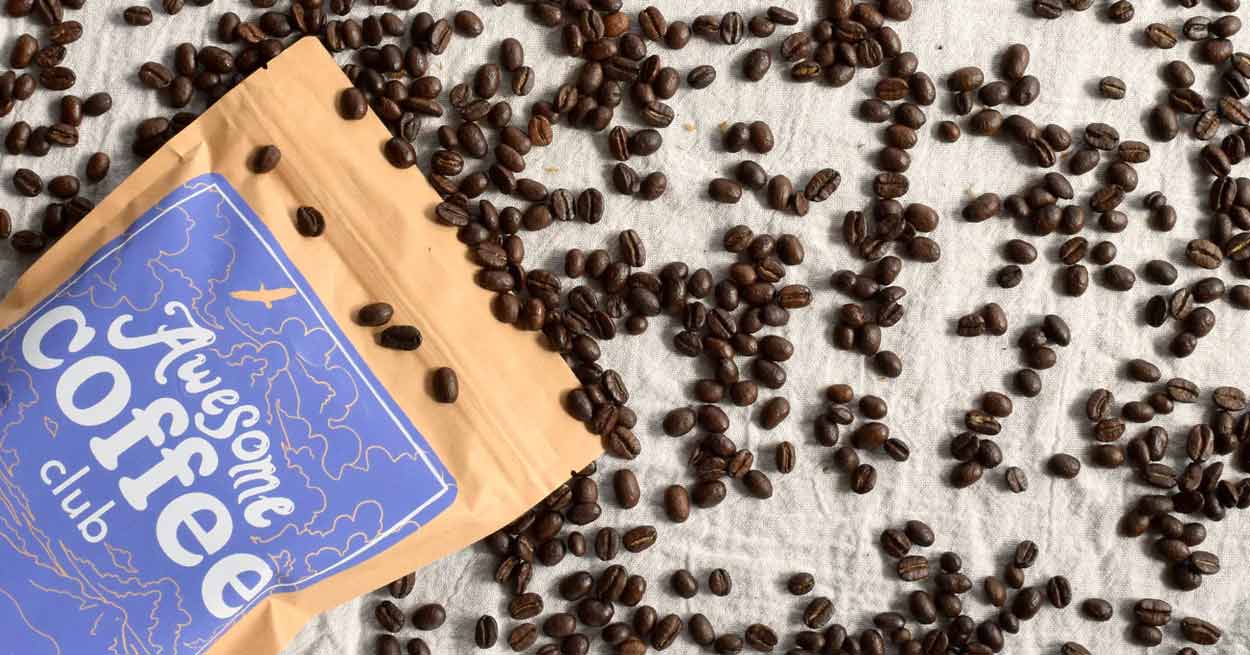 Awesome Coffee Club Packaging on a Pile of Coffee Beans