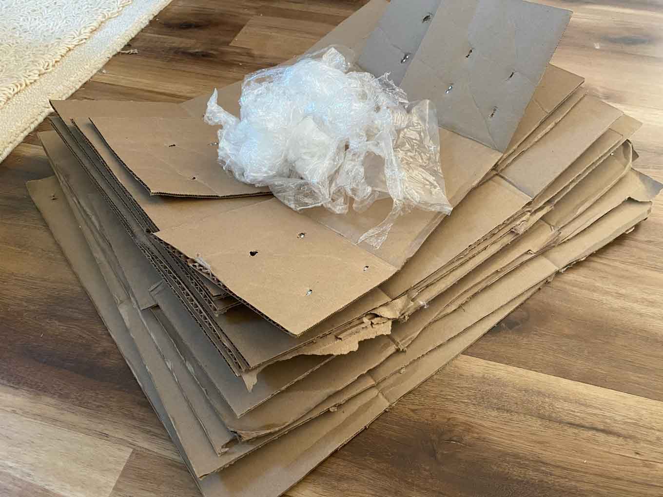 A pile of cardboard packaging with a small amount of plastic