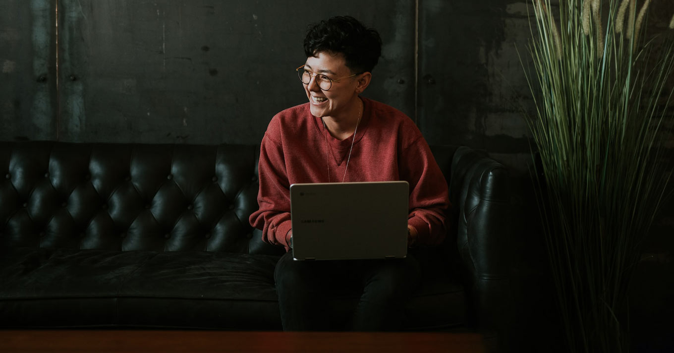Employee smiling at their computer