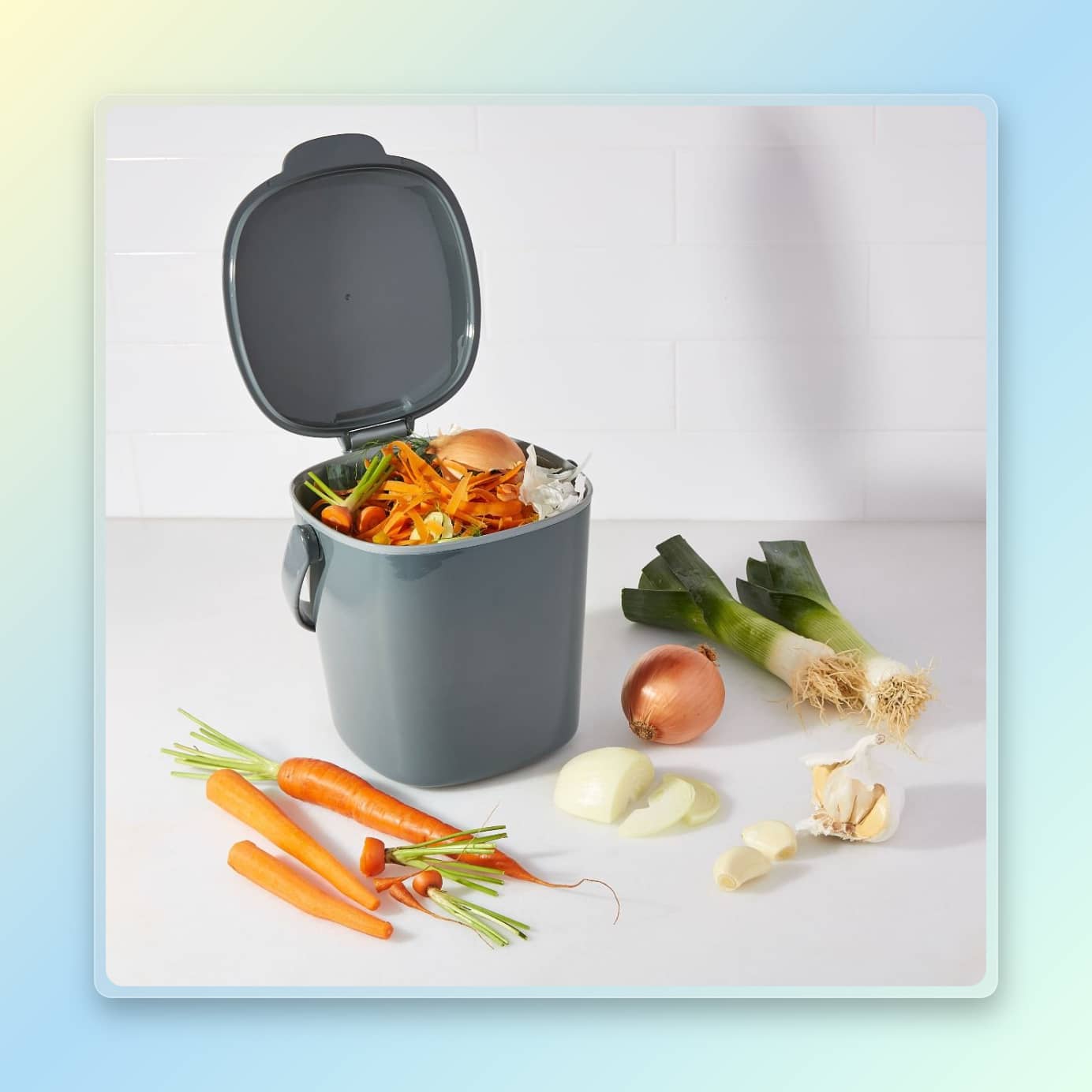 OXO minimalist compost bin filled with food on a counter with food