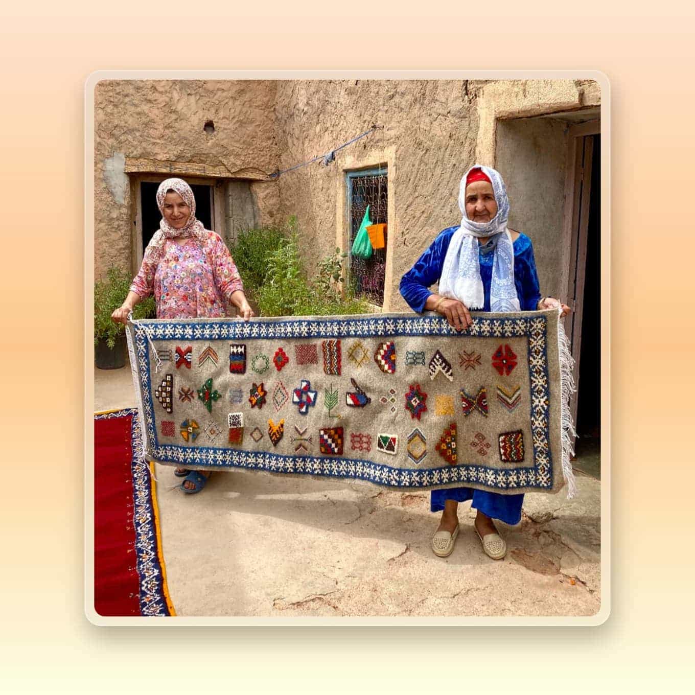 Two artisans hold an ethically made rug