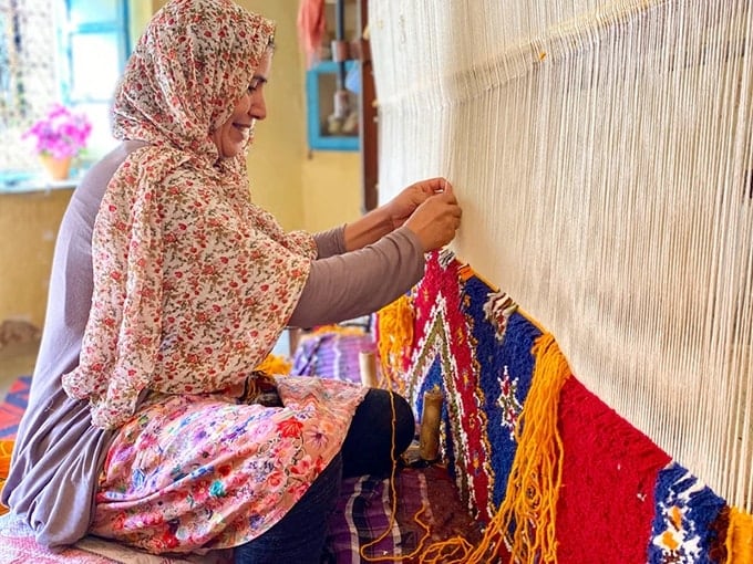 An artisan ethically weaves a new rug