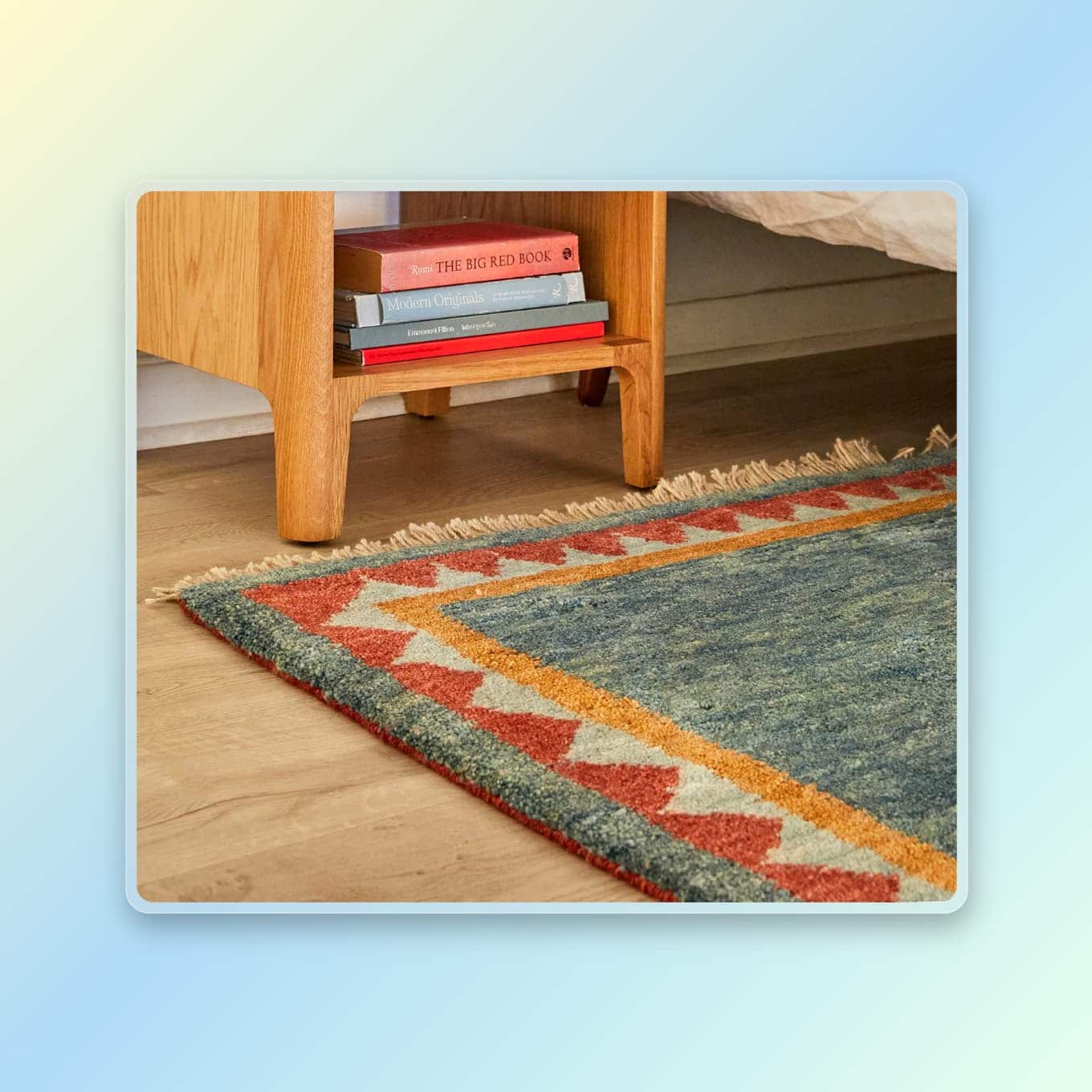 A colorful rug peeking out from under a bed