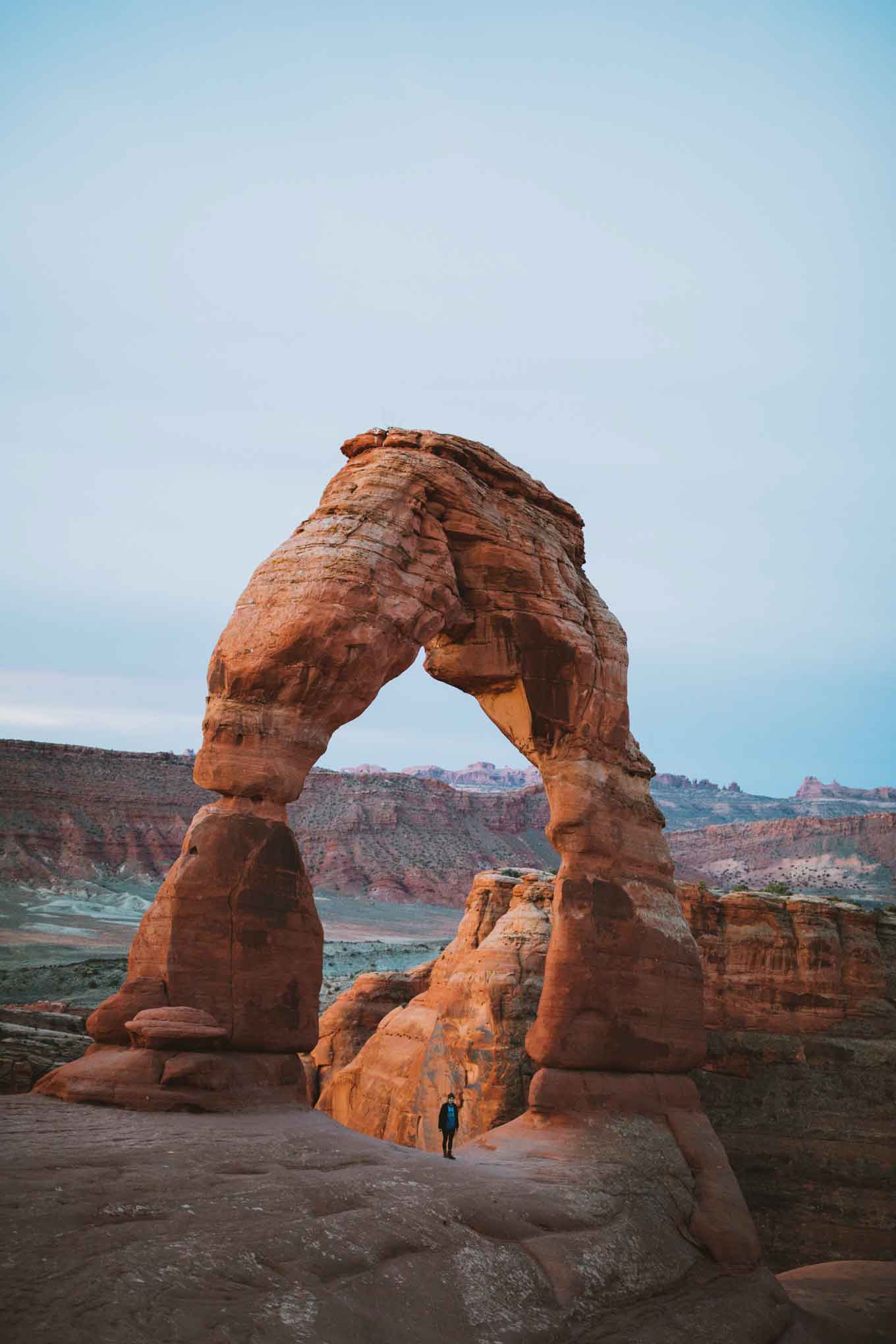 National park visitor stands at Arches National Park