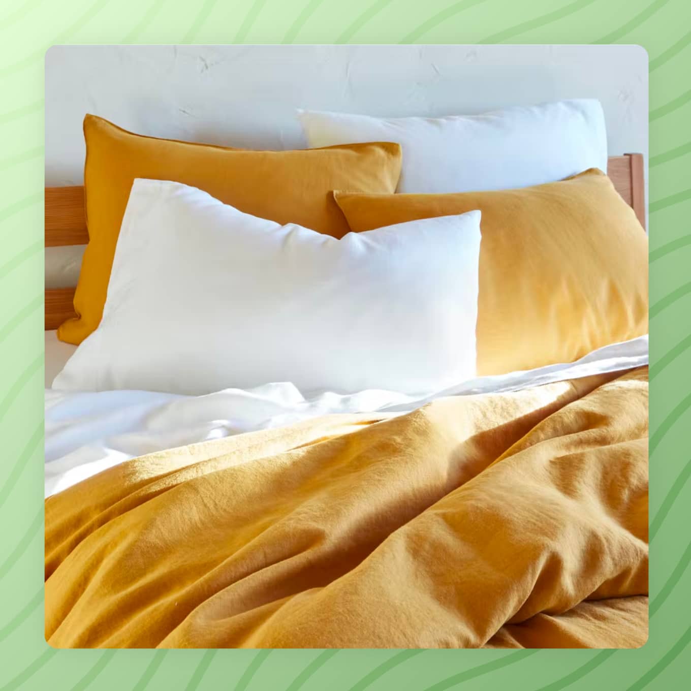A bed with yellow and white bedding
