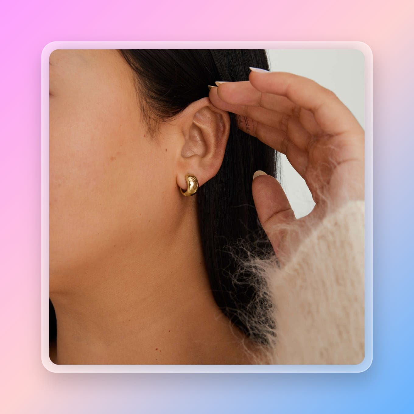 A woman wearing chunky gold hoops in her ears