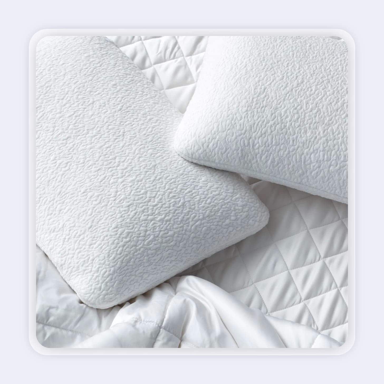 Closeup view of white pillows with a unique, curvy pattern