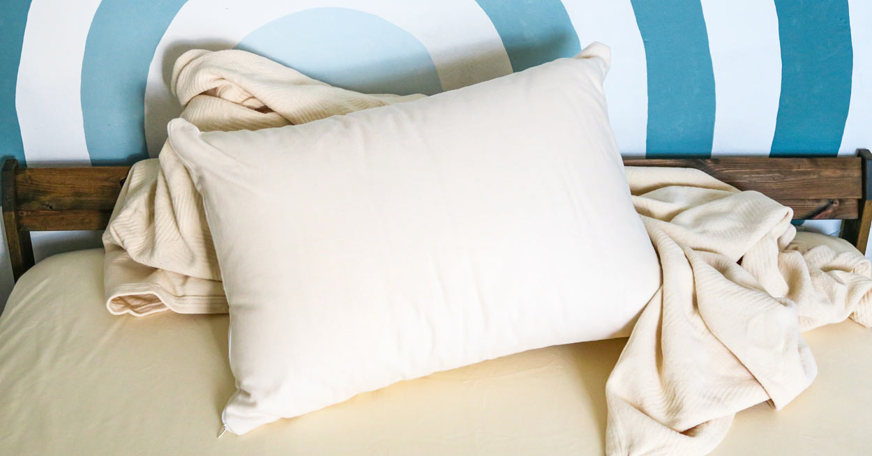 An eco-friendly pillow on a bed with a cute wall 