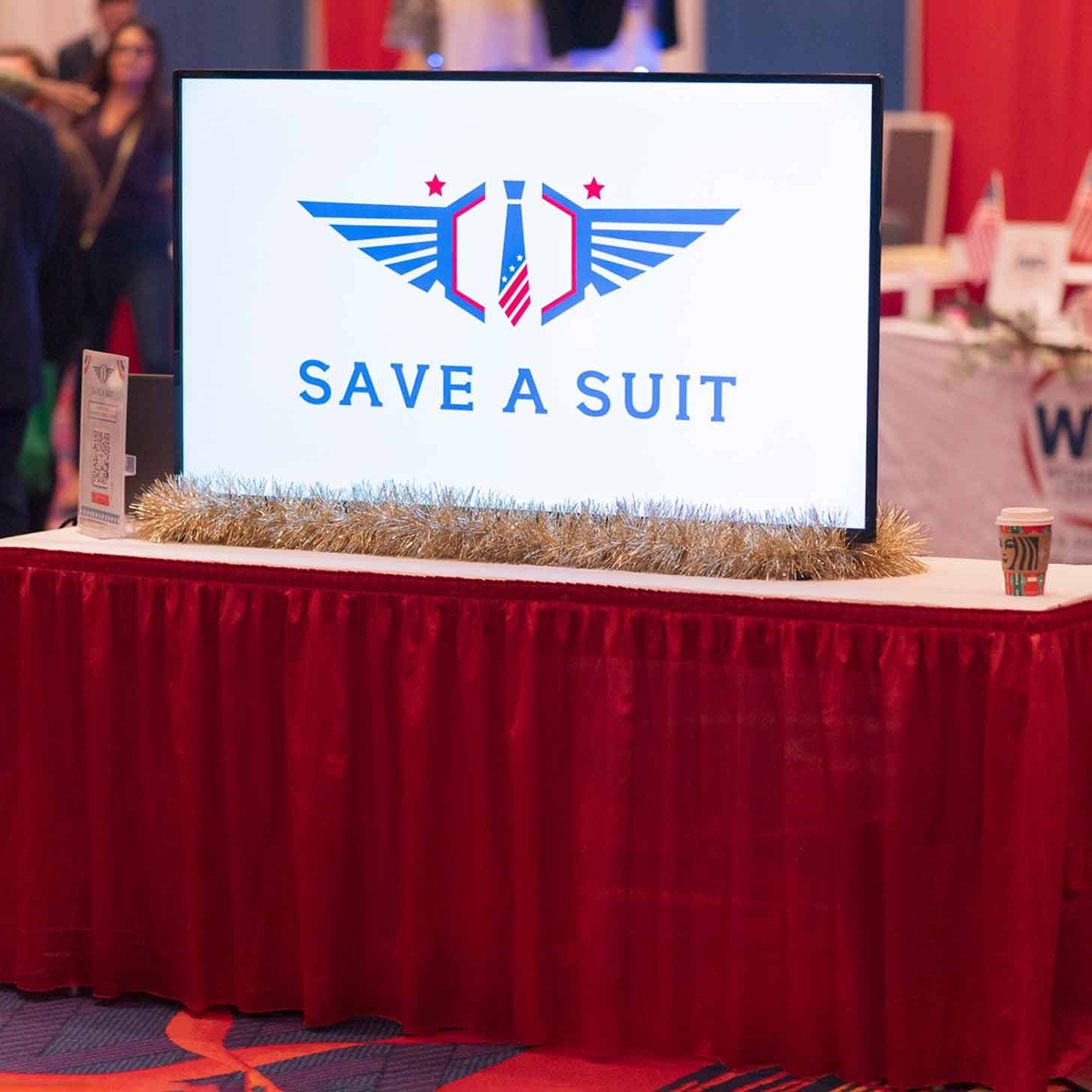 Veterans trying on professional clothes at a suiting event for Save a Suit