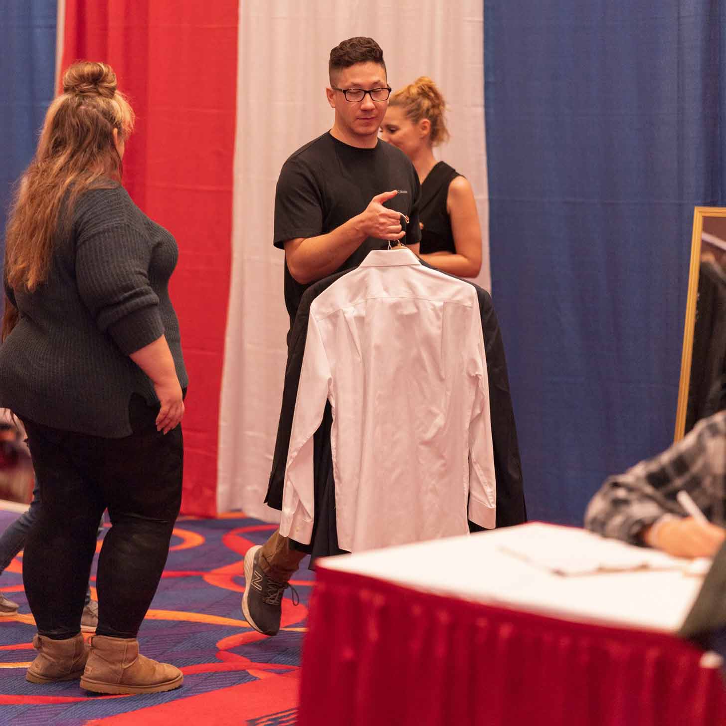 Veterans trying on professional clothes at a suiting event for Save a Suit