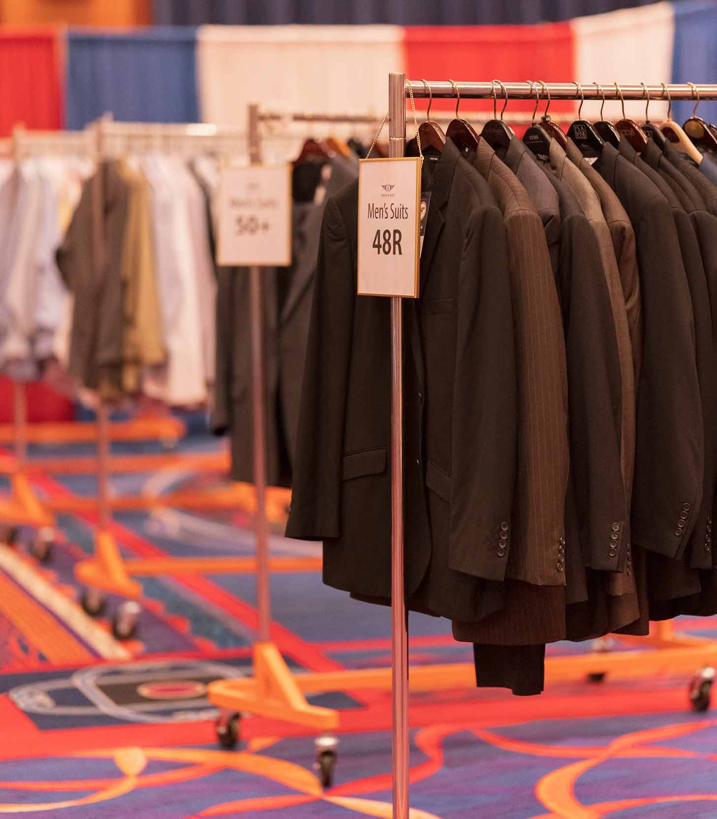 Rack of Men's Suits at a suiting event for Save a Suit