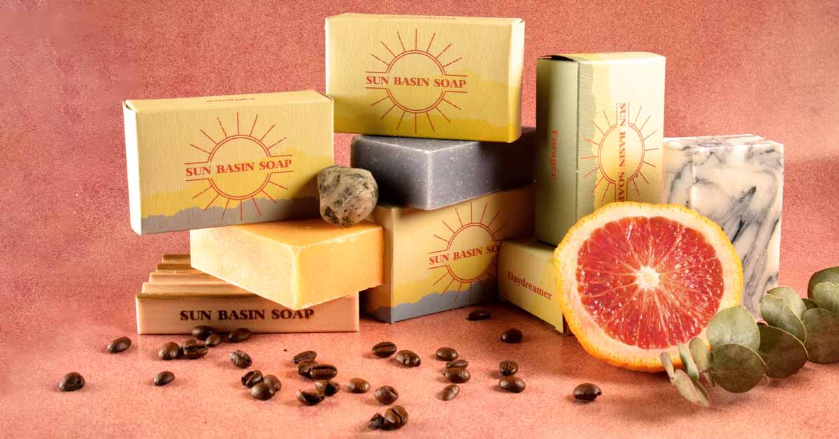 Soaps from Sun Basin Soap stacked next to fruits and coffee