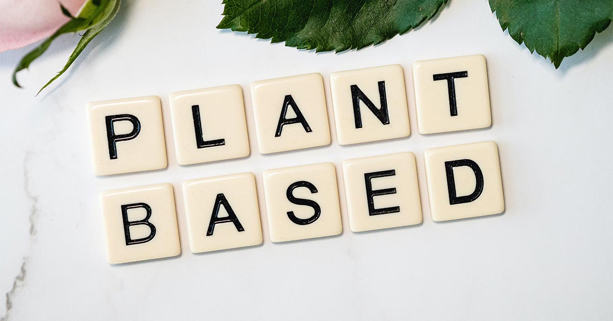 White and black wooden blocks that spell "Plant based"