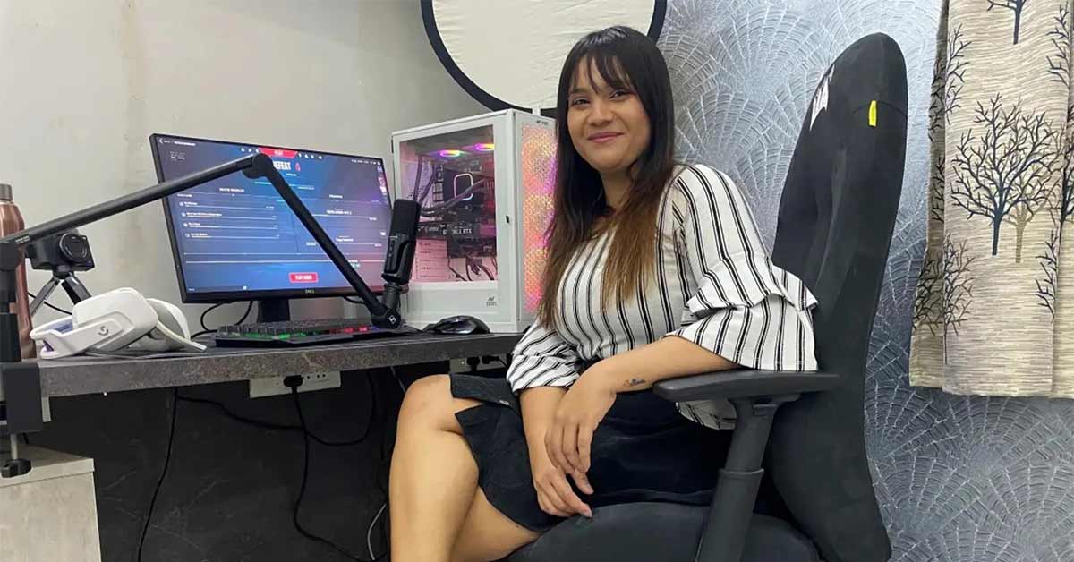 Sonali Singh poses by her computer with a smile on her face