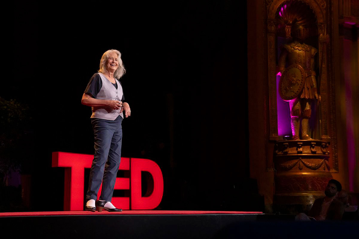 Isabella Kirkland smiles on stage at TED