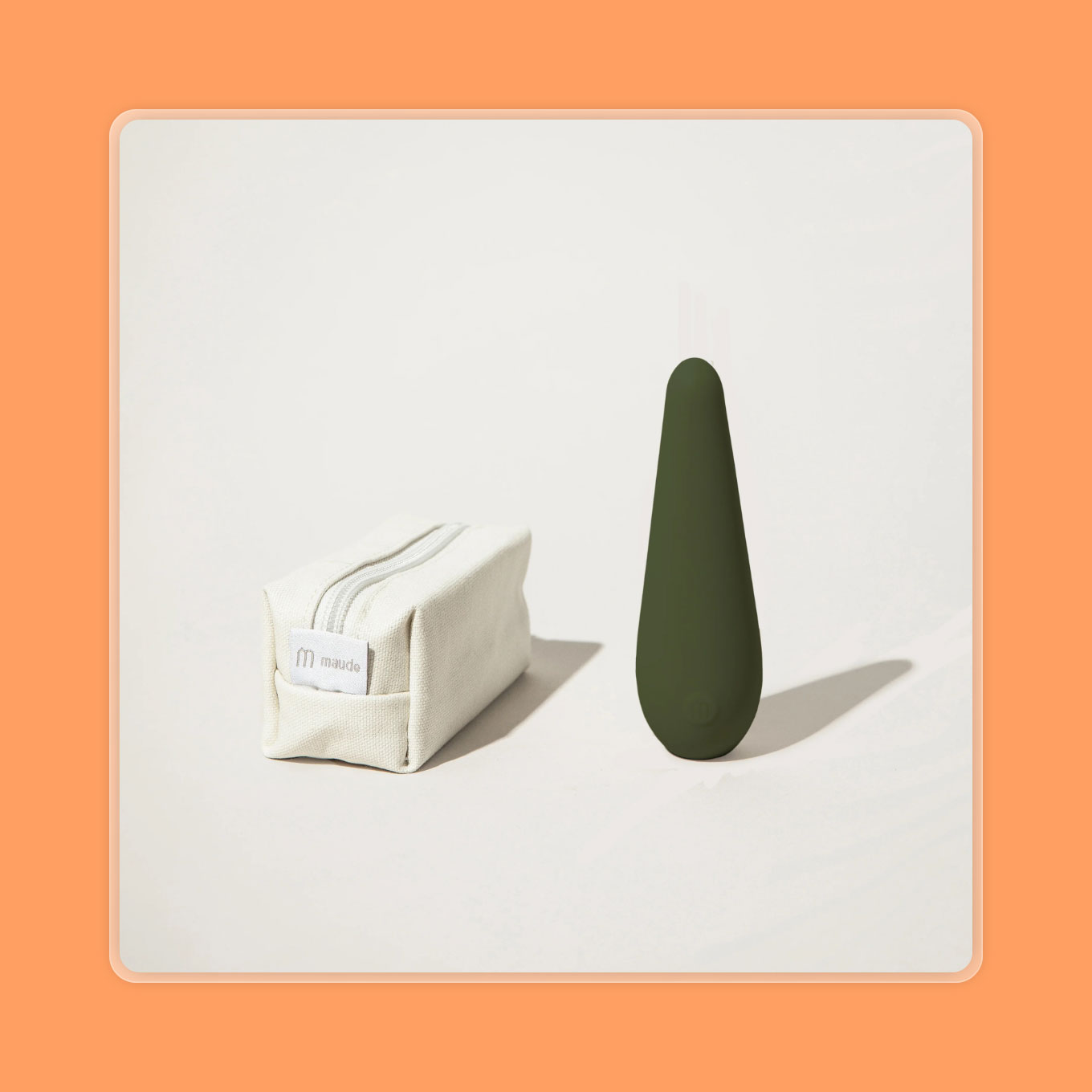 A forest green vibrator sits next to a canvas carrying pouch