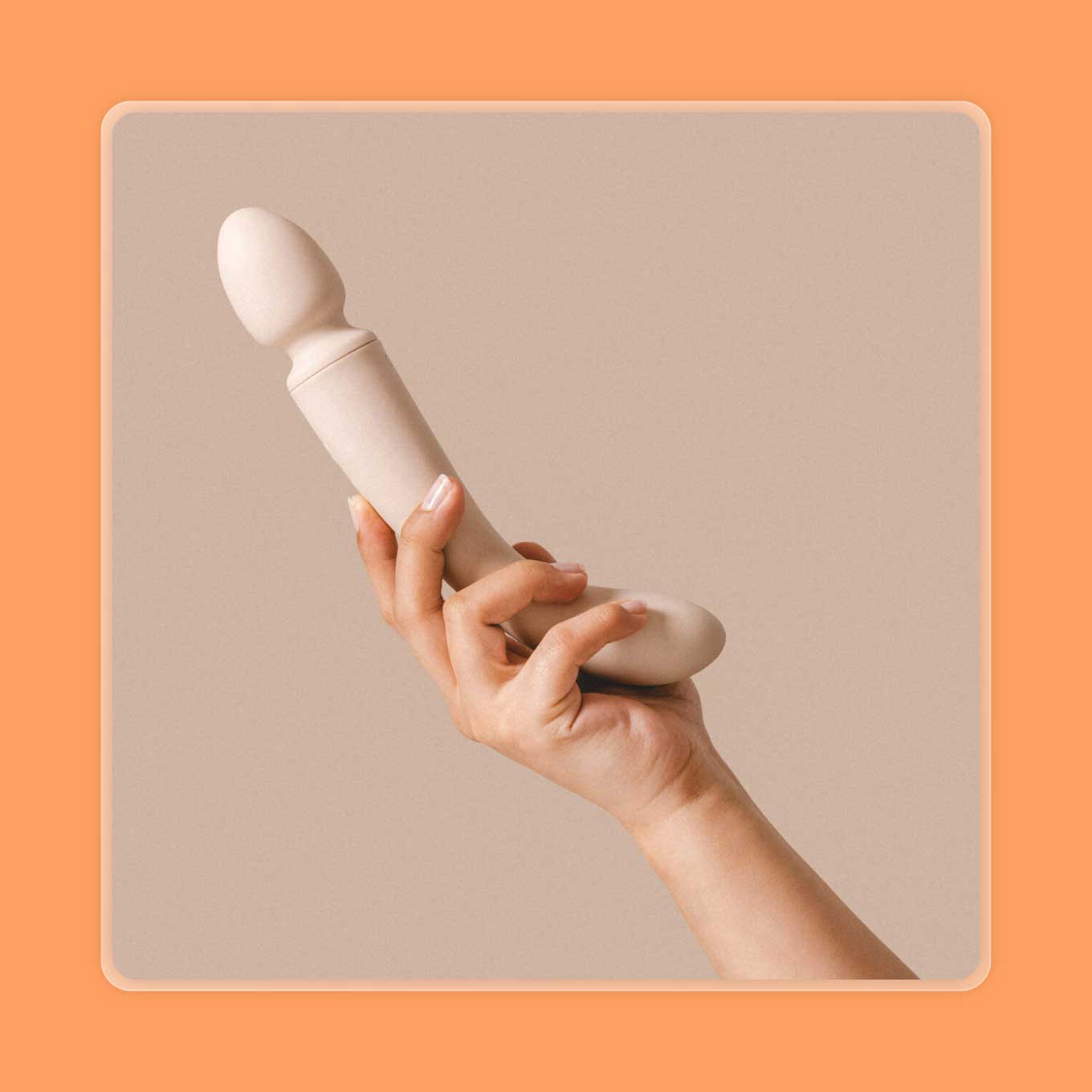 A hand holds up a white wand vibrator