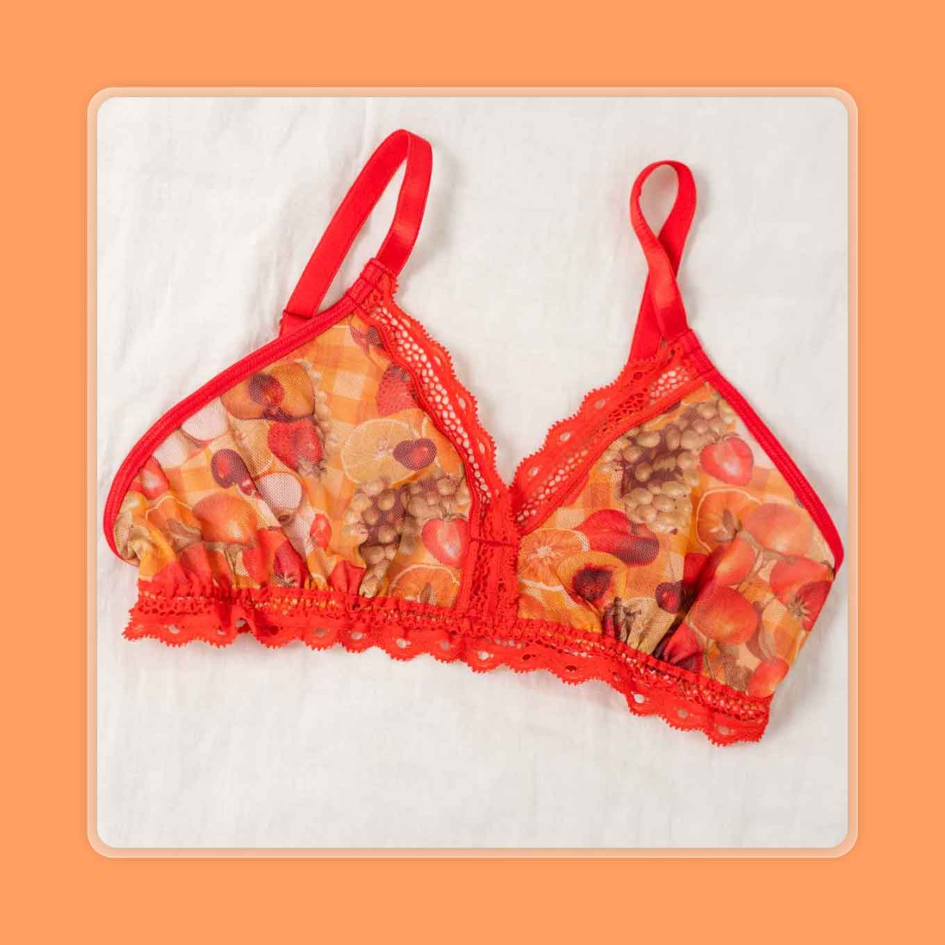 A red bralette with a fruit-themed print