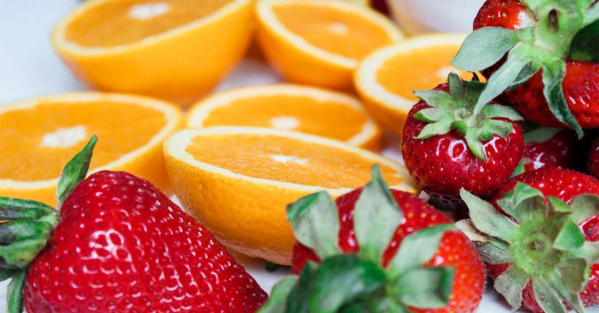 Sliced oranges and strawberries on a table
