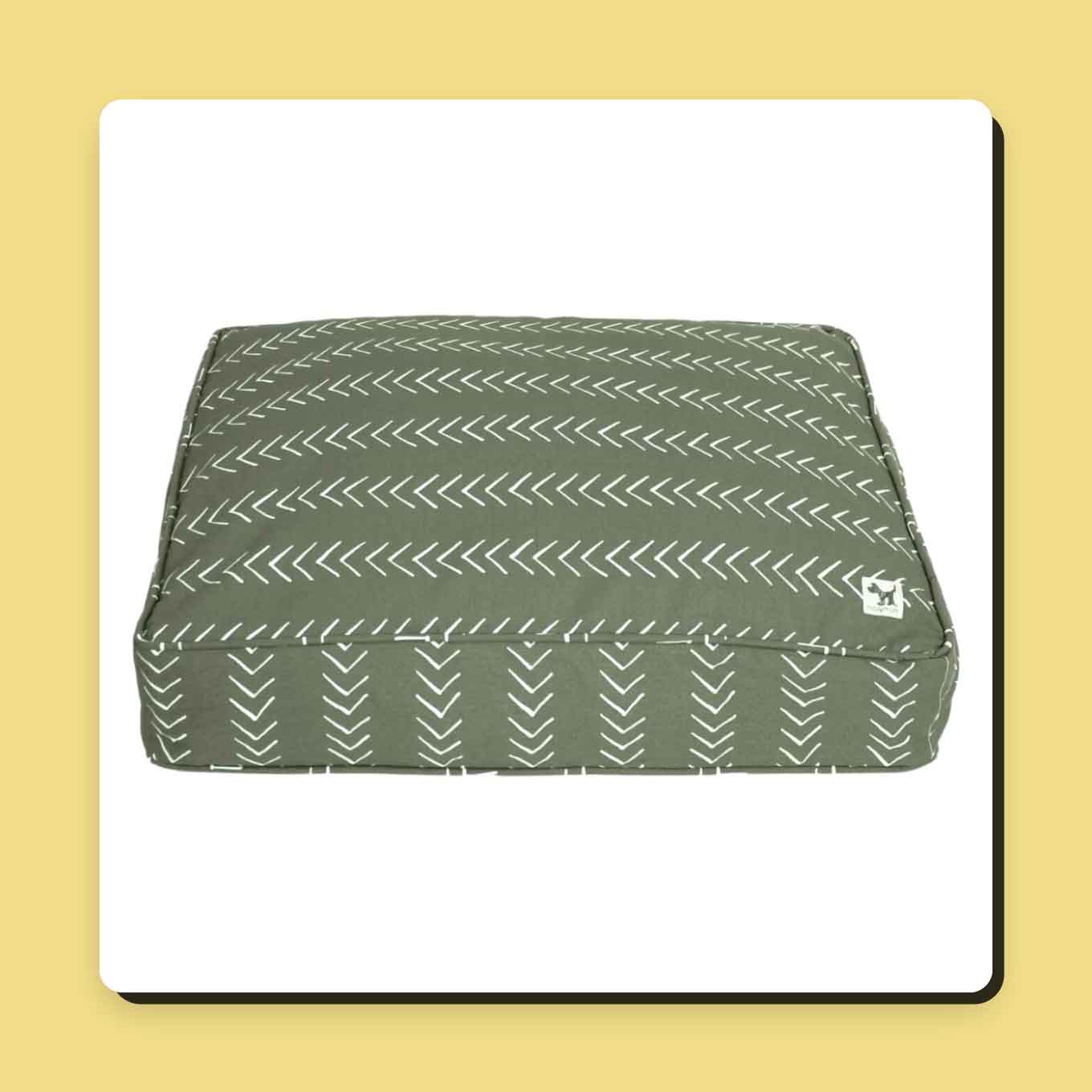 A green dog bed with a white chevron design