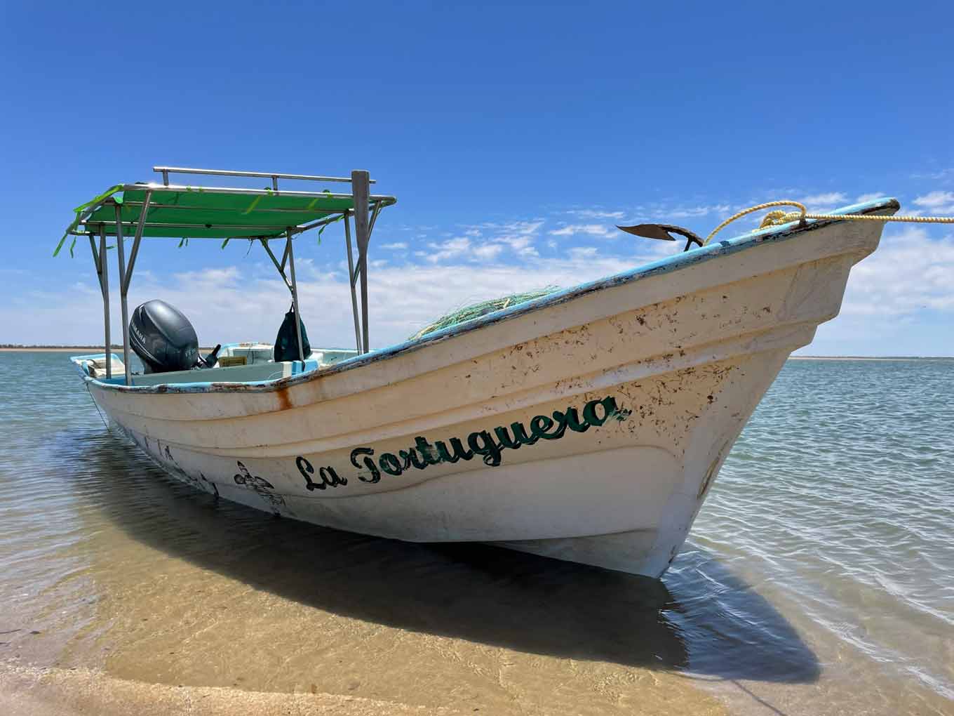 A boat called "La Tortuguera" at the shore