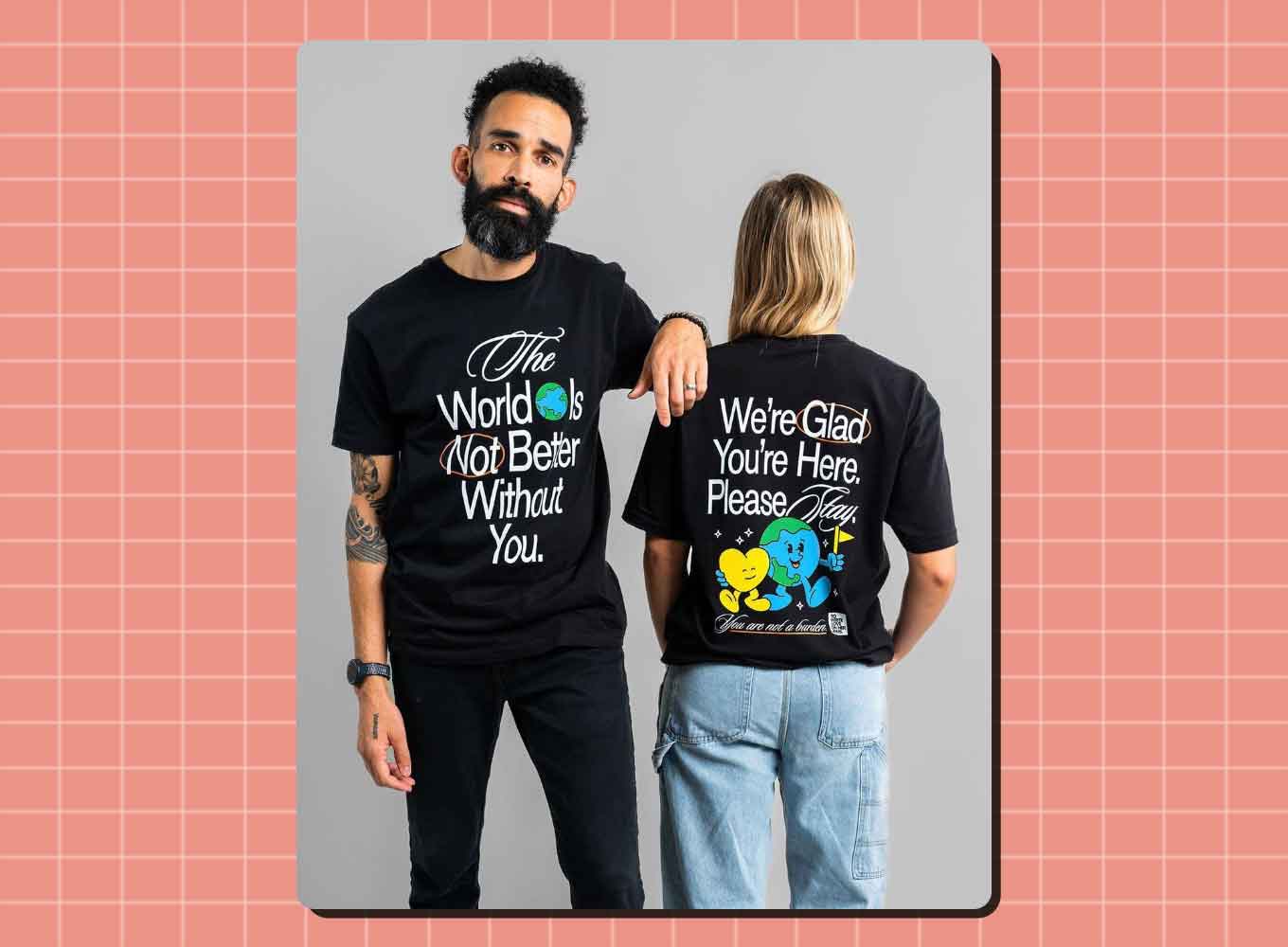 A man and a woman stand side by side, wearing t-shirts that say "The World Is Not Better Without You."