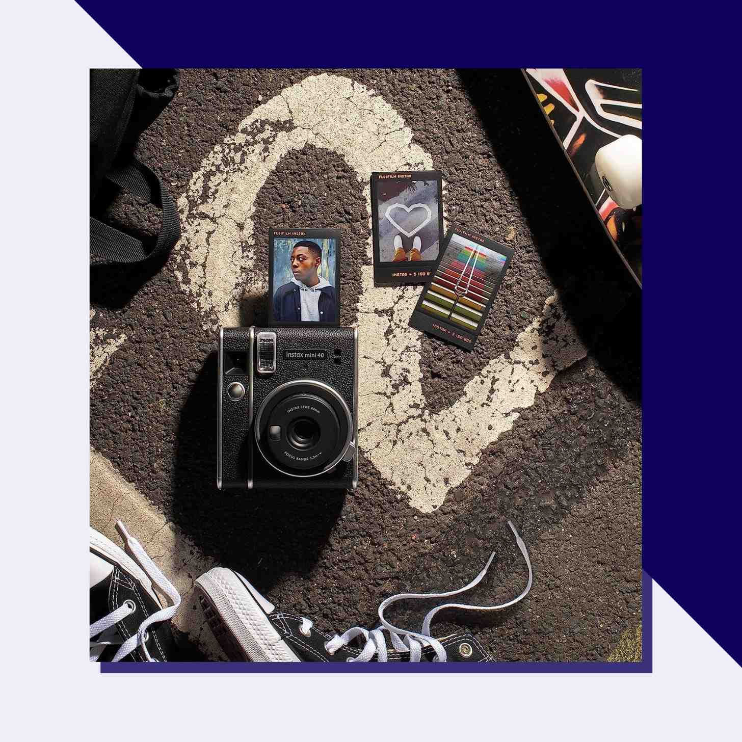 A Fujifilm Camera And Three Polaroid Pictures On the Asphalt