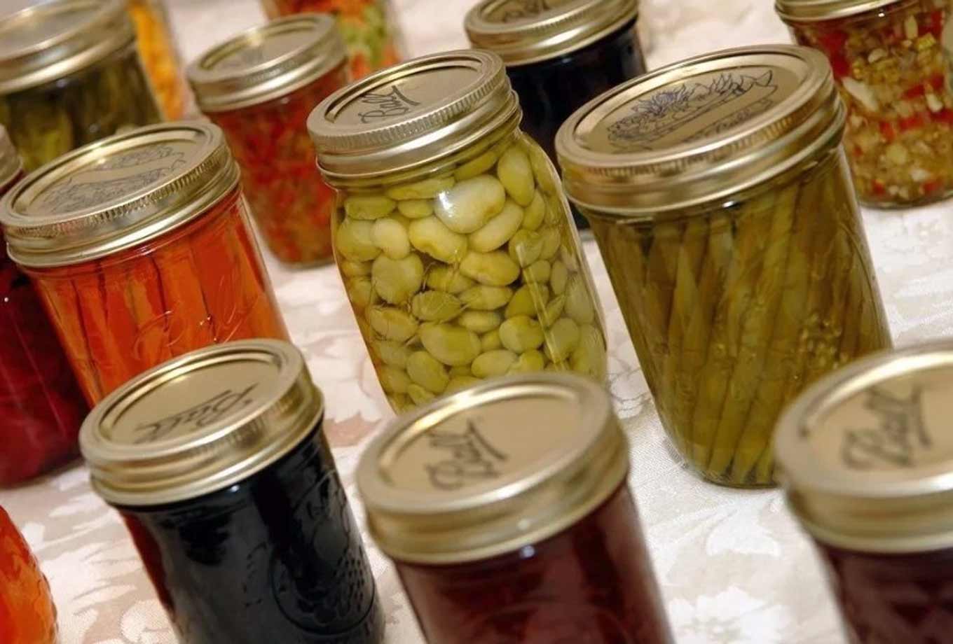 A variety of vegetables and fruits preserved in glass jars