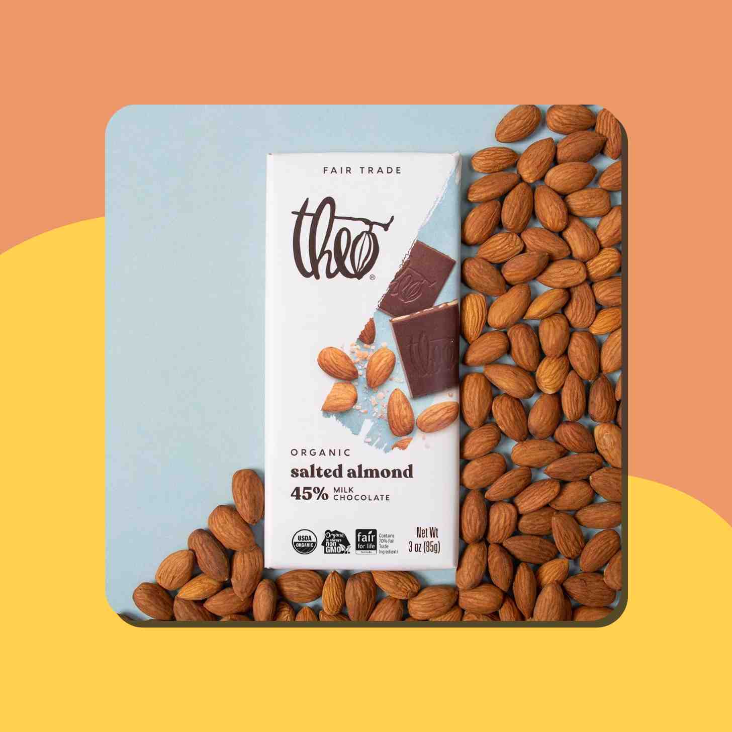 A Box Of Theo Organic Salted Almond Chocolate Sorrounded By Almonds