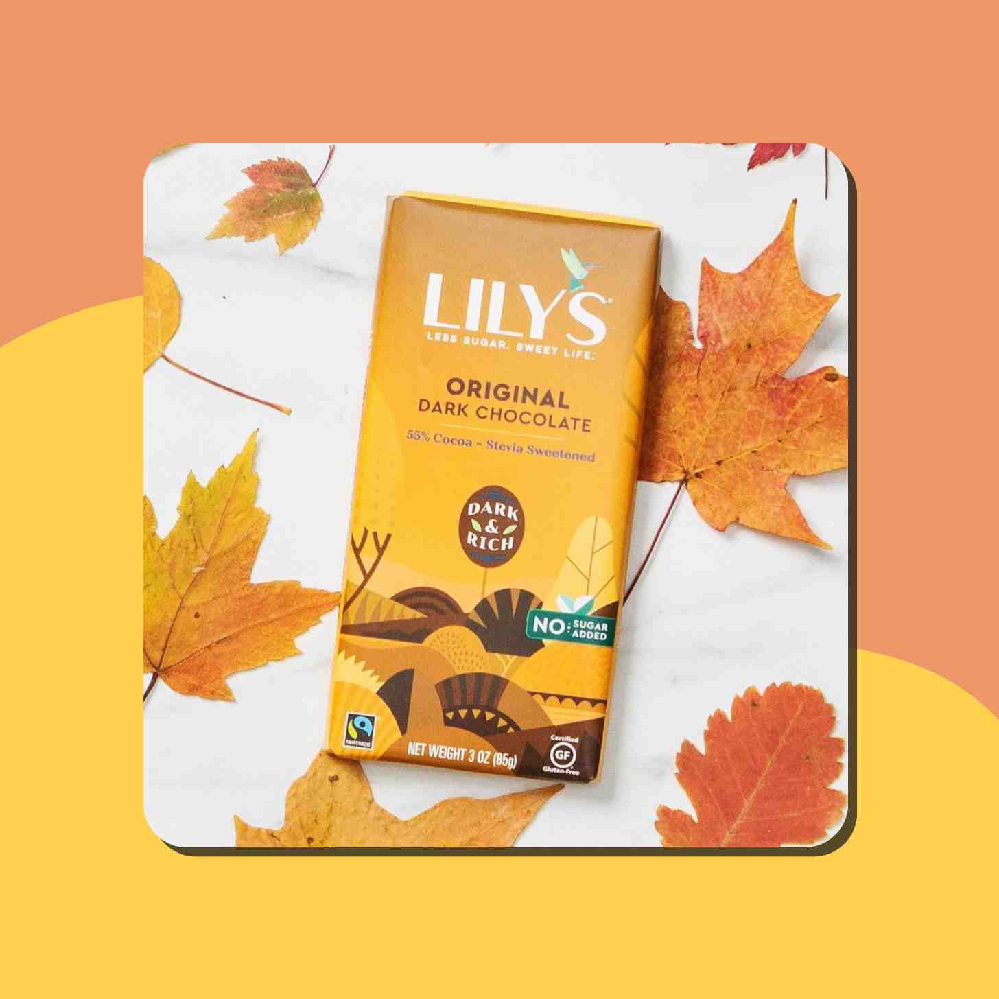 A Box Of Lily's Original Dark Chocolate Sorrounded by Maple Leaves 